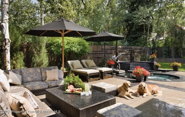 a backyard of a house with table and chairs