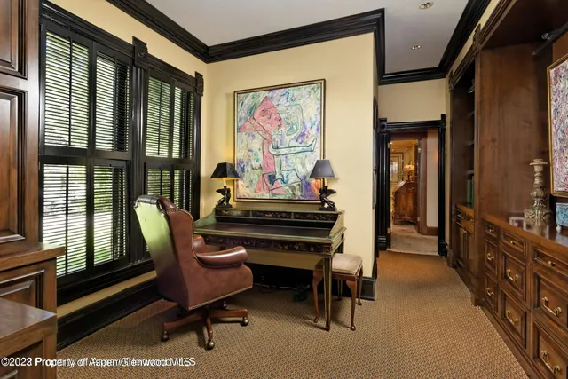 a living room with furniture and a piano