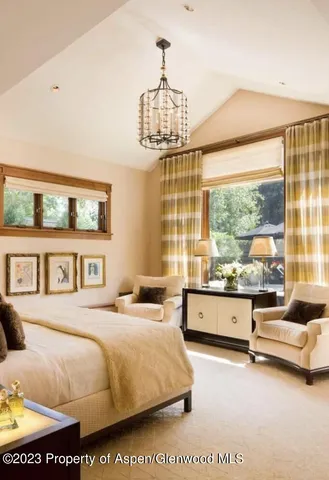 a spacious bedroom with a bed and a large window