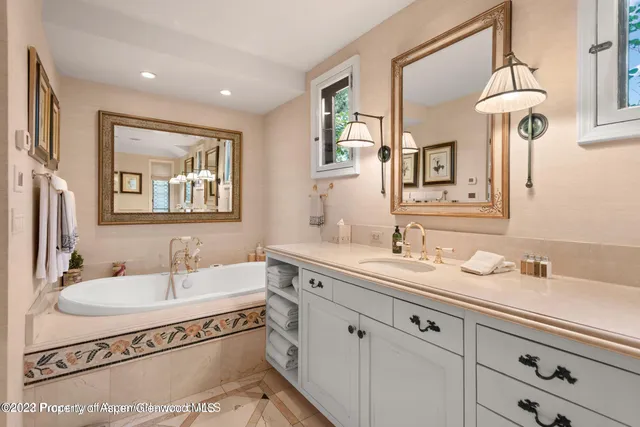 a spacious bathroom with a sink double vanity and a mirror