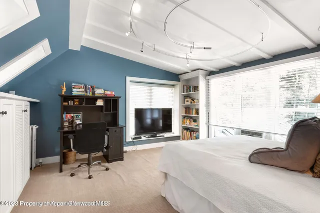 a view of a livingroom with furniture and a flat screen tv