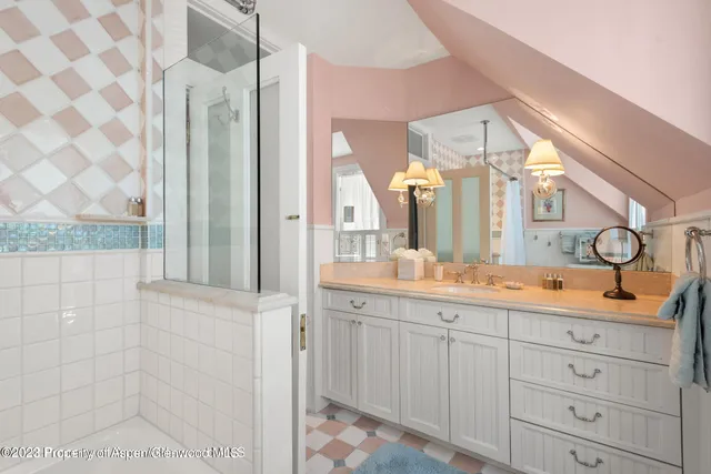 a spacious bathroom with a granite countertop sink mirror and shower