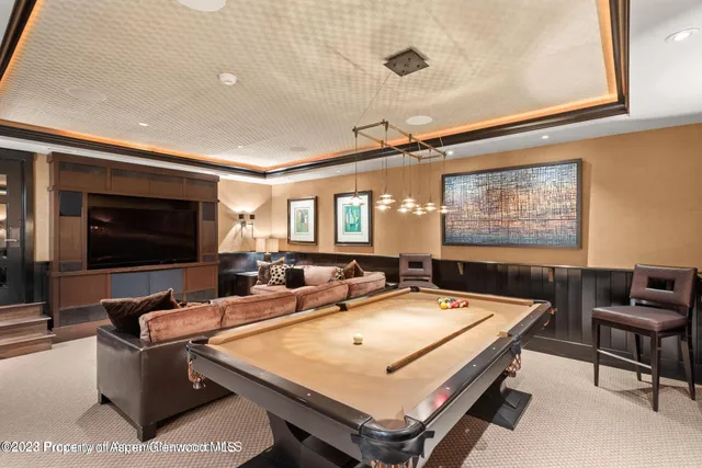 a room with pool table and flat screen tv