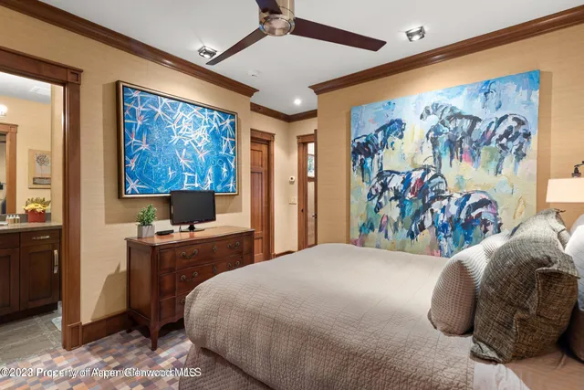 a bedroom with a bed and a chandelier