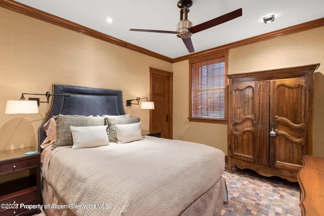 a bedroom with a large bed and a large window