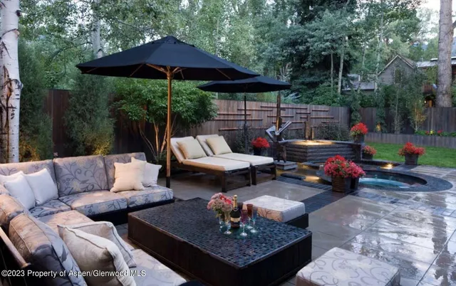 a backyard of a house with table and chairs