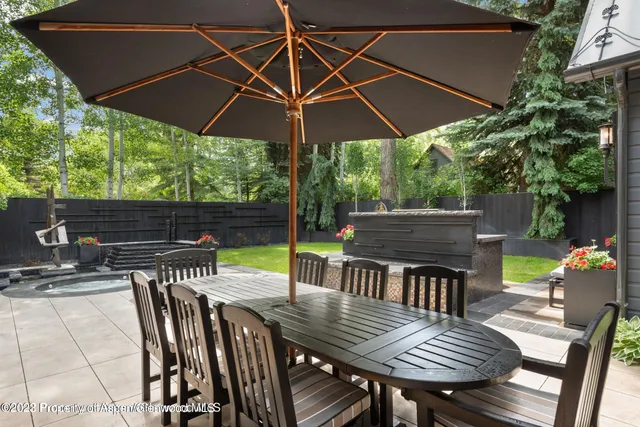 a view of backyard with seating space and wooden floor