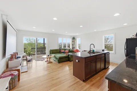 a living room with furniture windows and a flat screen tv