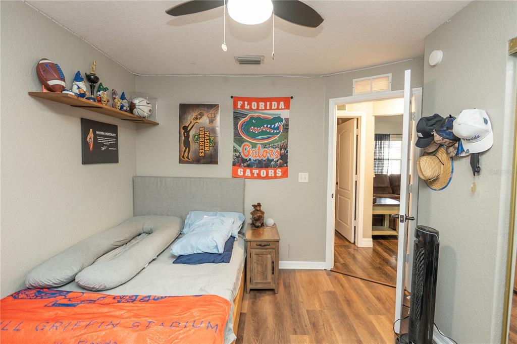 6 Fir Drive Trace Ocala, FL 34472 - Photo 21 of 41 a bedroom with a bed and a chandelier