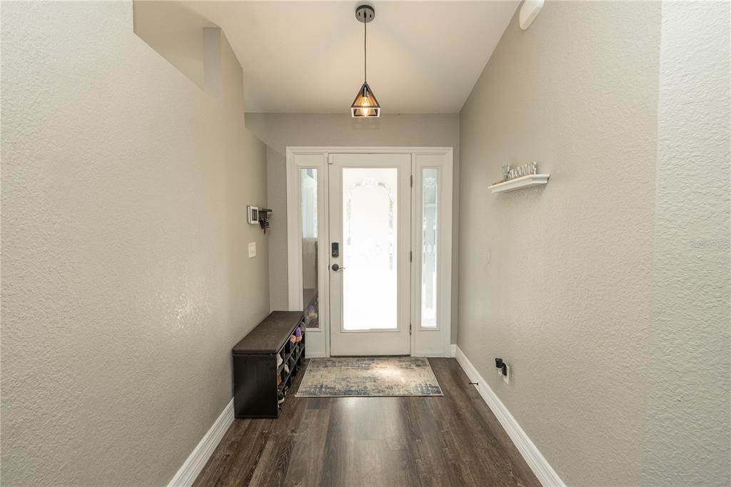 6 Fir Drive Trace Ocala, FL 34472 - Photo 4 of 41 a view of a hallway with wooden floor and a window