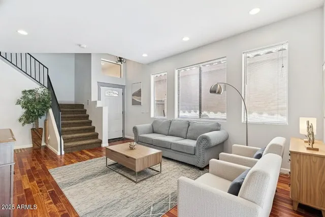 a living room with furniture and wooden floor