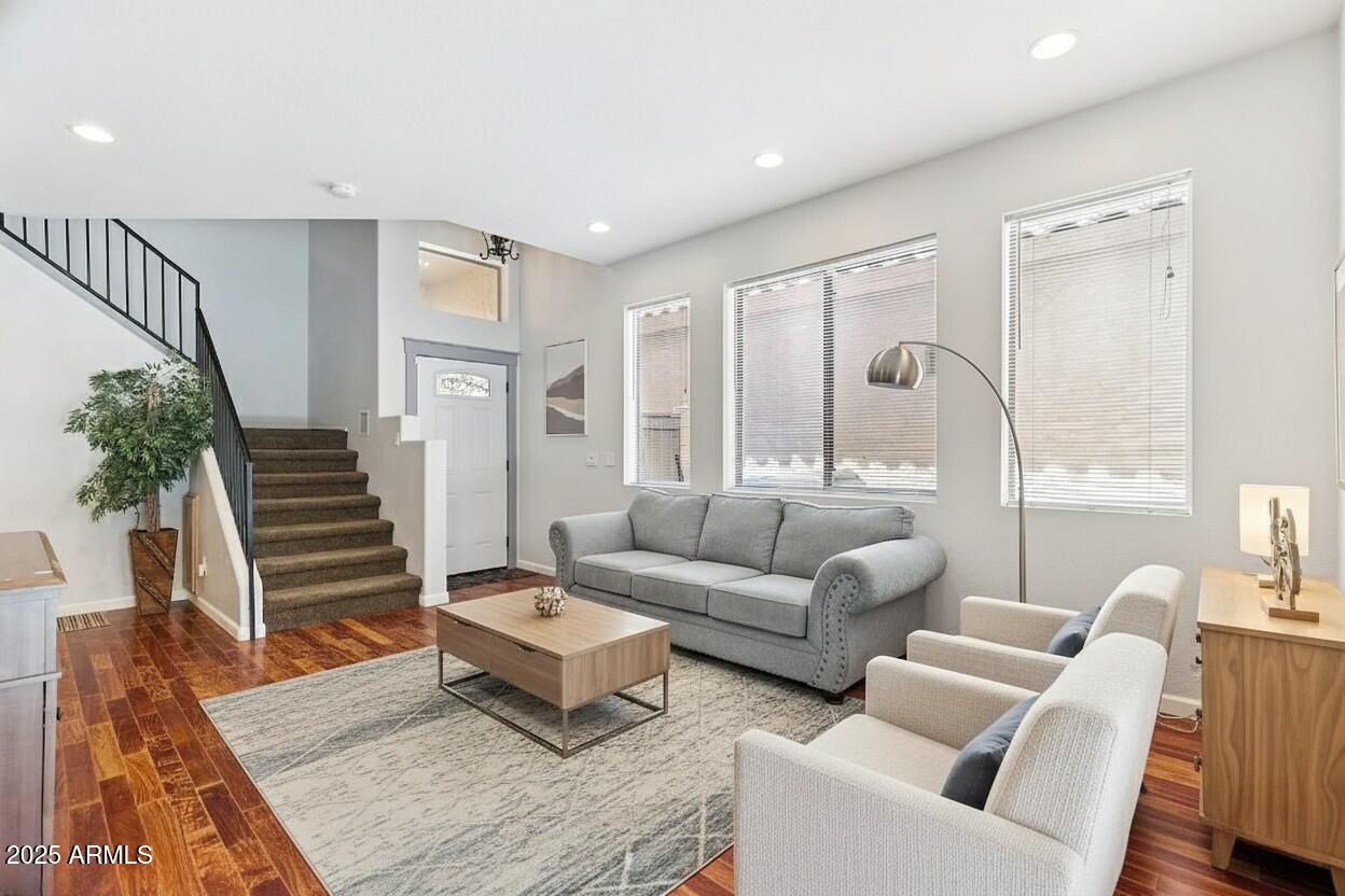 a living room with furniture and wooden floor