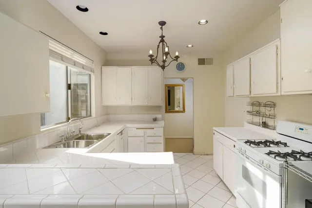 a kitchen with a stove a sink and a refrigerator