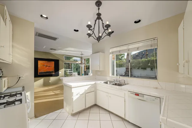 a kitchen with stainless steel appliances a sink and cabinets