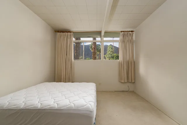 a room with a bed and a window
