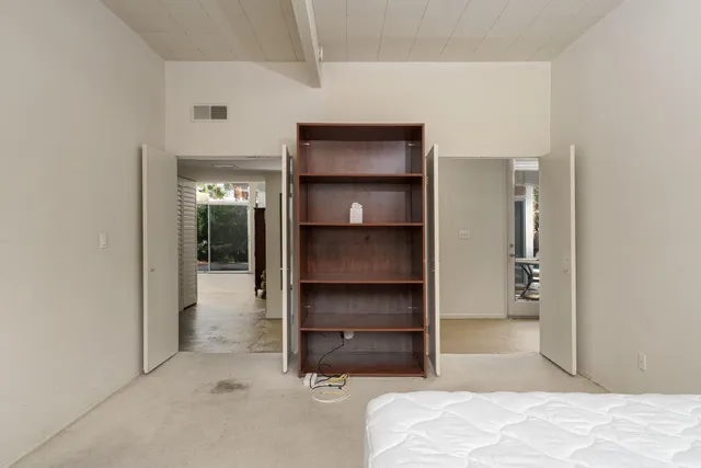 a bedroom with a bed and a bathroom