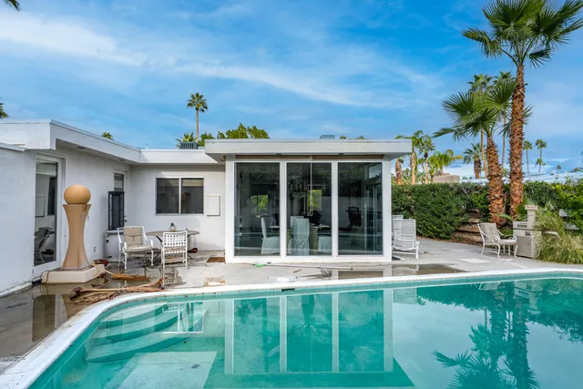 a view of a house with backyard porch and sitting area