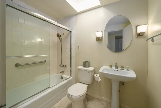 a bathroom with a toilet sink and shower