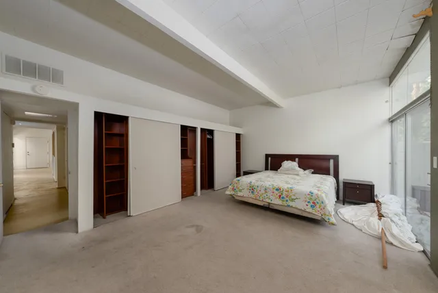 a bedroom with a bed and a cabinets