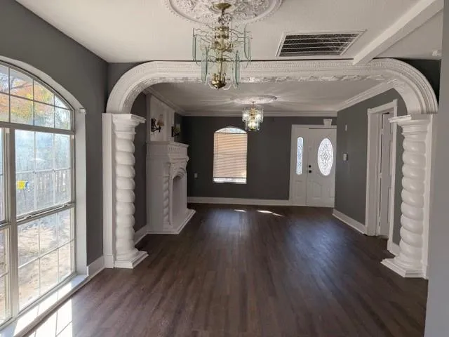 a view of gallery with chandelier and wooden floor