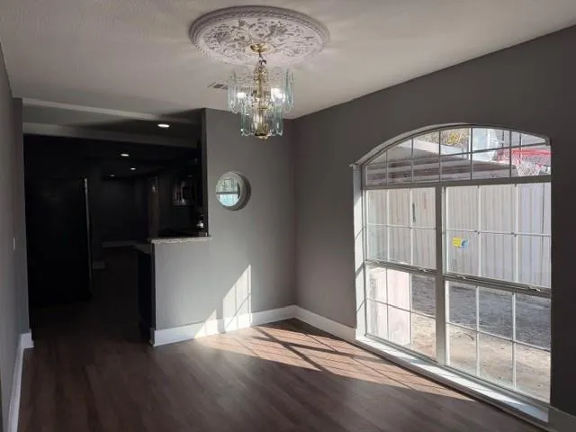 wooden floor in an empty room with a window