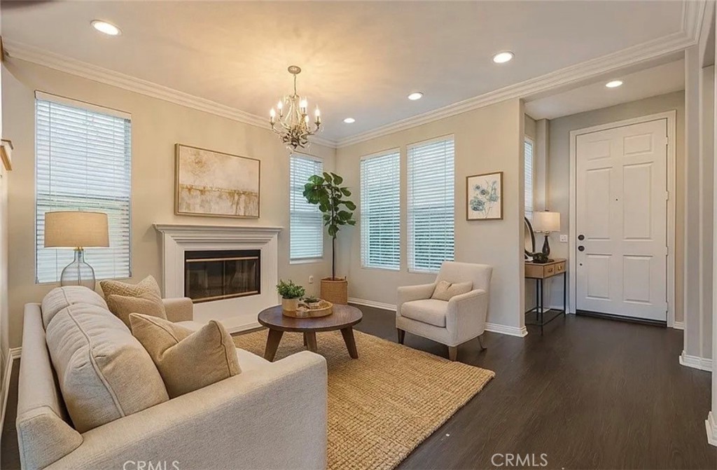 3715 Club Rancho Drive Palmdale, CA 93551 - Photo 11 of 52 a living room with furniture a chandelier and a fireplace