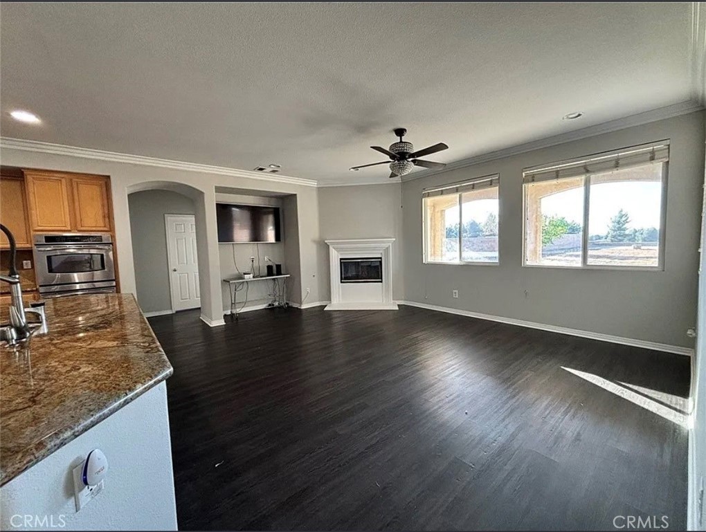 3715 Club Rancho Drive Palmdale, CA 93551 - Photo 13 of 52 an open kitchen with granite countertop a stove and a wooden floors