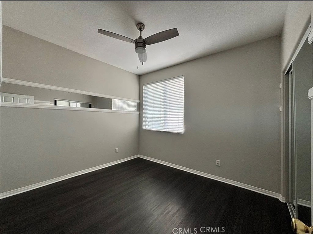 3715 Club Rancho Drive Palmdale, CA 93551 - Photo 16 of 52 an empty room with wooden floor and windows
