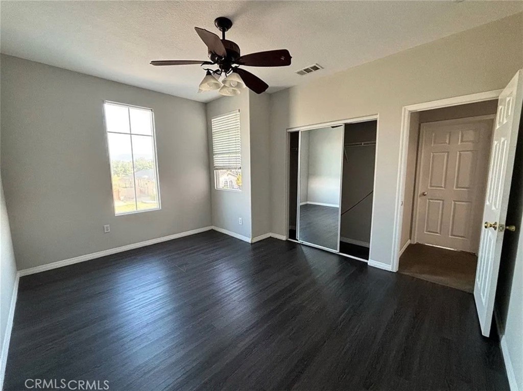 3715 Club Rancho Drive Palmdale, CA 93551 - Photo 28 of 52 a view of an empty room with wooden floor and a window