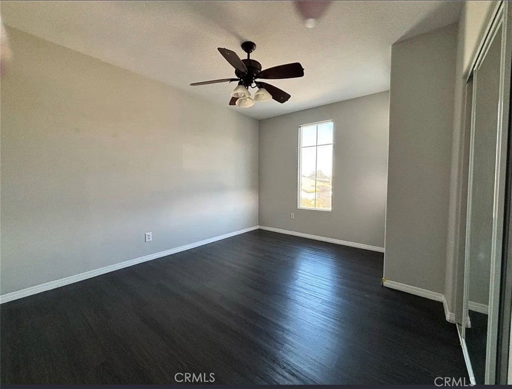 3715 Club Rancho Drive Palmdale, CA 93551 - Photo 30 of 52 an empty room with wooden floor fan and windows