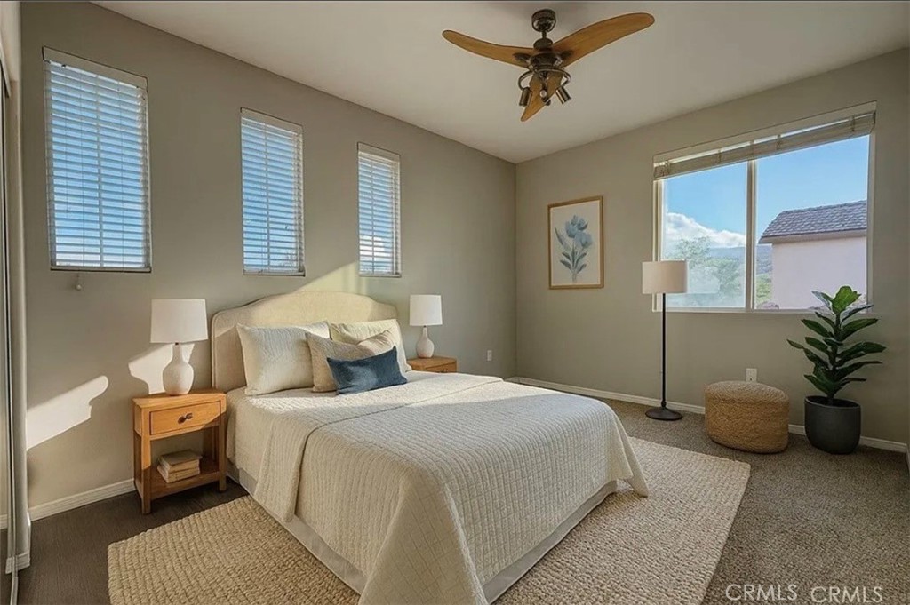 3715 Club Rancho Drive Palmdale, CA 93551 - Photo 35 of 52 a bedroom with a bed and a chandelier