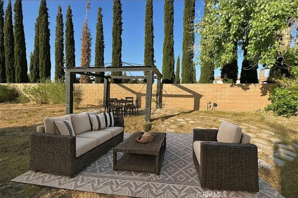 3715 Club Rancho Drive Palmdale, CA 93551 - Photo 46 of 52 a view of a patio with couches and a fire pit