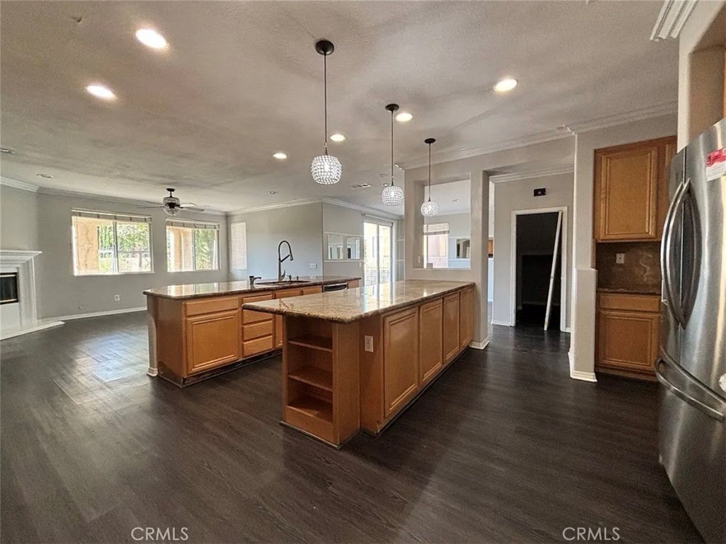 3715 Club Rancho Drive Palmdale, CA 93551 - Photo 8 of 52 a large kitchen with stainless steel appliances kitchen island a large counter top and a wooden floors