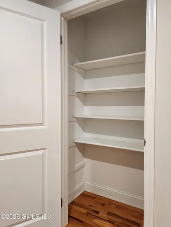 a view of walk in closet with empty racks
