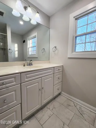 a spacious bathroom with a sink mirror and a vanity