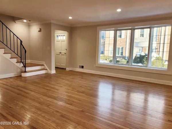 wooden floor in an empty room with a window