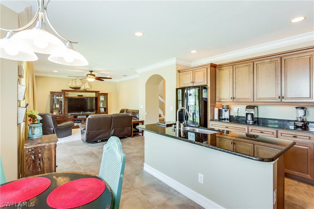 8517 Sumner Avenue Fort Myers, FL 33908 - Photo 11 of 25 a living room with furniture a flat screen tv and a large window