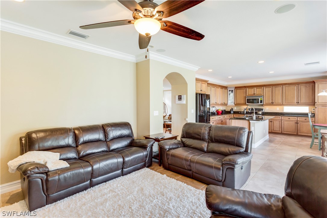 8517 Sumner Avenue Fort Myers, FL 33908 - Photo 13 of 25 a living room with furniture kitchen view and a chandelier