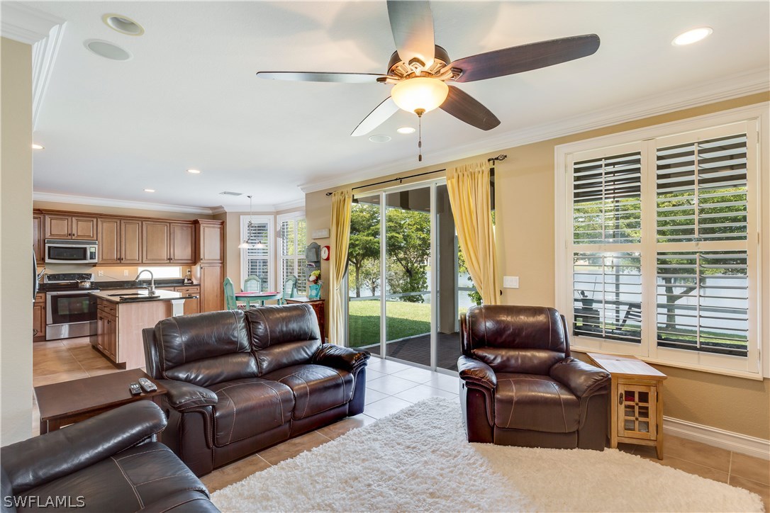 8517 Sumner Avenue Fort Myers, FL 33908 - Photo 14 of 25 a living room with furniture and a large window with kitchen view