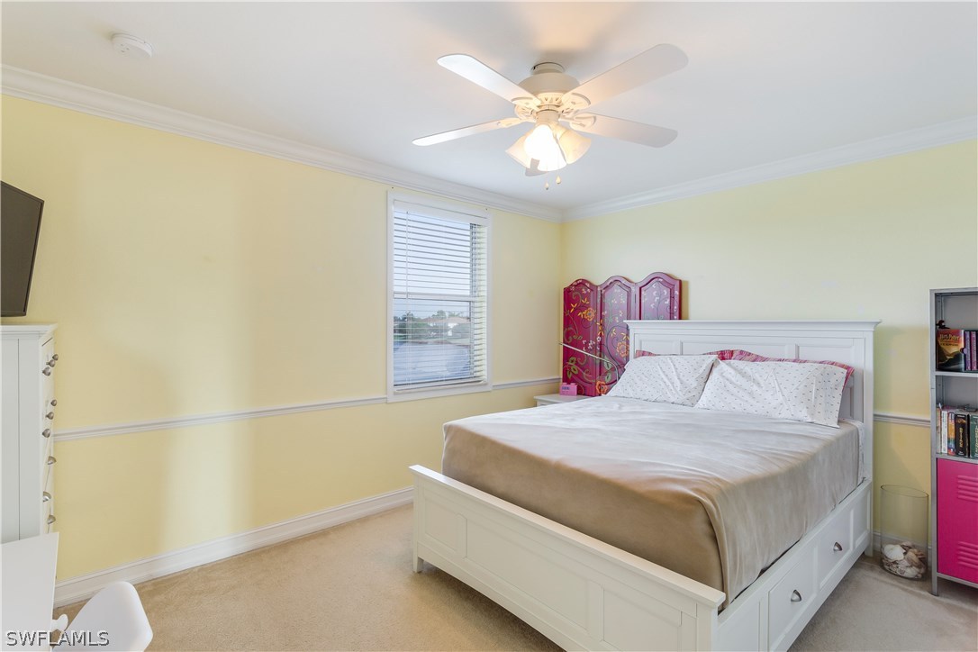 8517 Sumner Avenue Fort Myers, FL 33908 - Photo 17 of 25 a bedroom with a bed and a chandelier