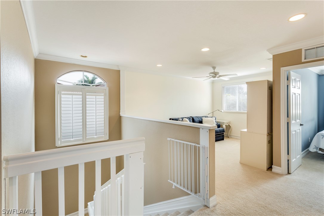 8517 Sumner Avenue Fort Myers, FL 33908 - Photo 21 of 25 a view of a hallway with windows and chandelier