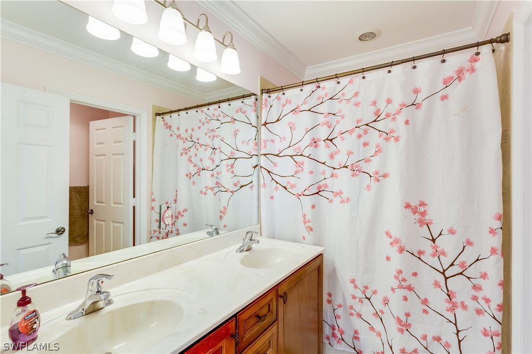 8517 Sumner Avenue Fort Myers, FL 33908 - Photo 23 of 25 a bathroom with a sink and a mirror