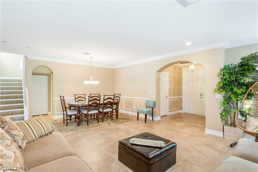 8517 Sumner Avenue Fort Myers, FL 33908 - Photo 4 of 25 a living room with furniture a dining table with kitchen view and a potted plant