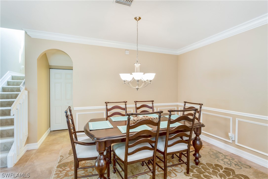8517 Sumner Avenue Fort Myers, FL 33908 - Photo 5 of 25 a view of a dining room with furniture and chandelier