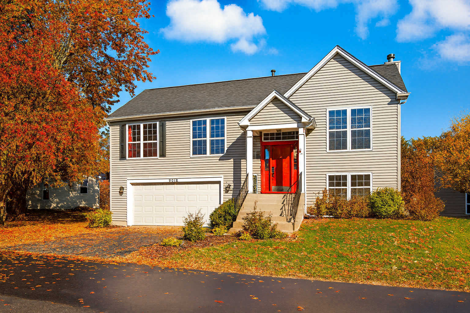 2019 Aspen Drive Woodstock, IL 60098 - Photo 1 of 31 a front view of a house with a yard