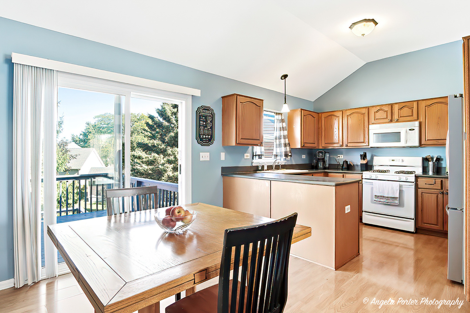 2019 Aspen Drive Woodstock, IL 60098 - Photo 2 of 31 a kitchen with stainless steel appliances granite countertop a stove a refrigerator a kitchen island a stove and a dining table