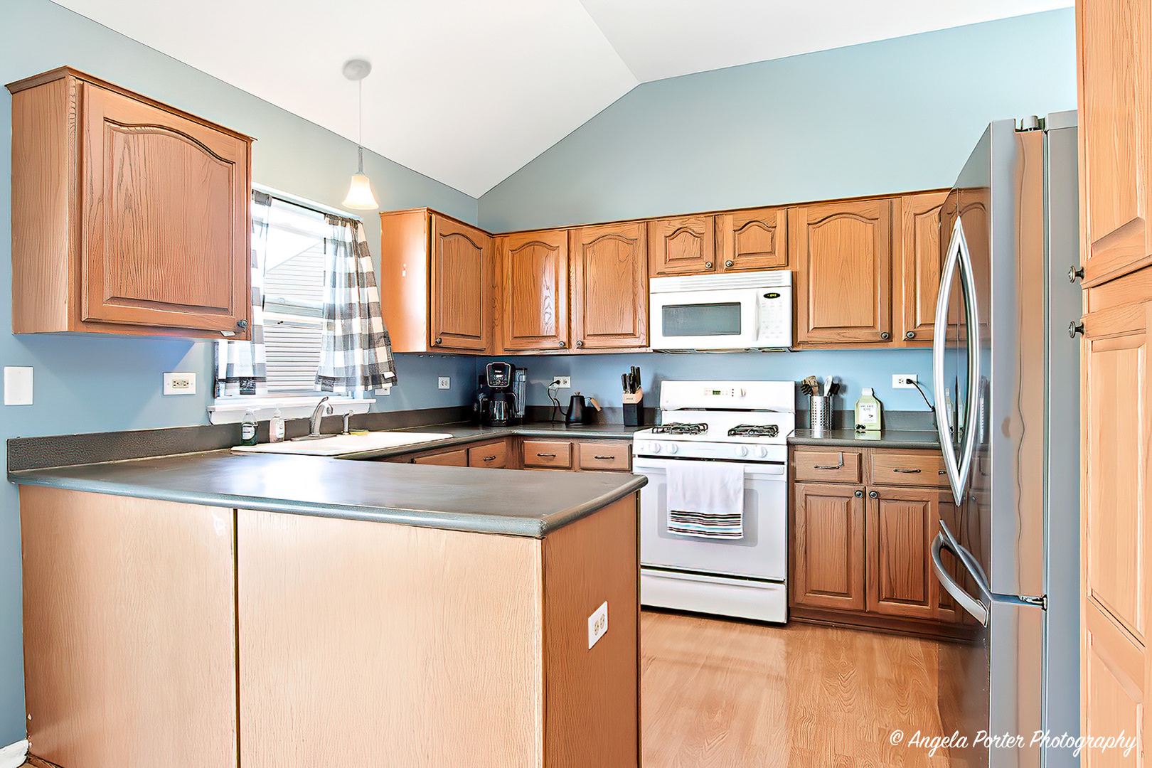 2019 Aspen Drive Woodstock, IL 60098 - Photo 7 of 31 a kitchen with stainless steel appliances granite countertop a sink a stove and a refrigerator