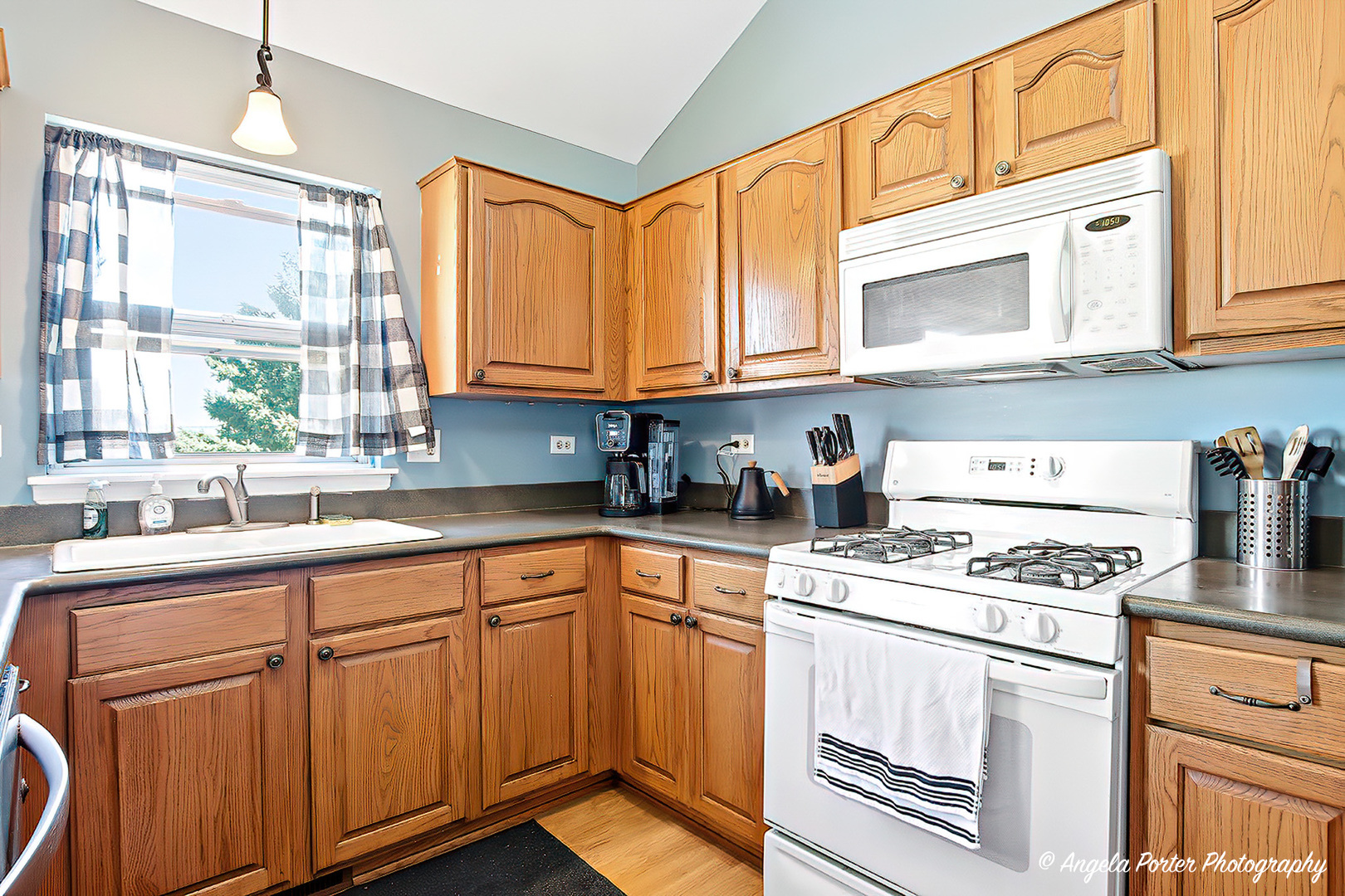 2019 Aspen Drive Woodstock, IL 60098 - Photo 8 of 31 a kitchen with cabinets appliances a sink and a window