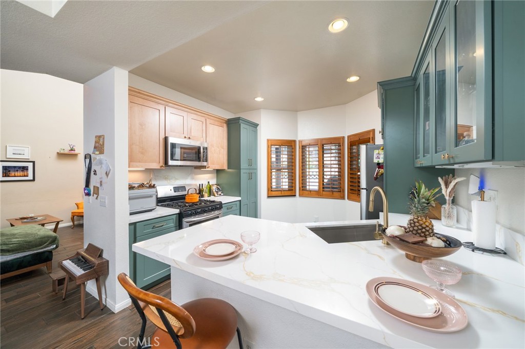3707 Calle Curacso Riverside, CA 92503 - Photo 1 of 43 a kitchen with sink refrigerator dining table and chairs