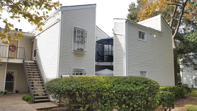 a view of a house with a yard and plants
